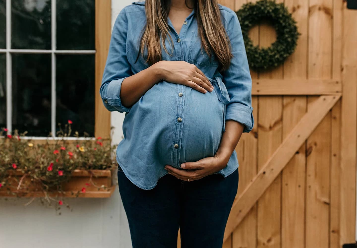 A pregnant woman holding her belly